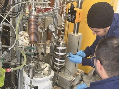 Two NanosTech engineers running a pilot-scale reactor trial